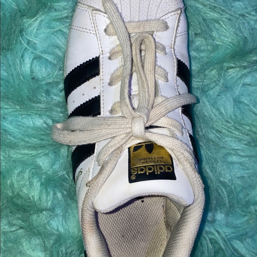 Worn adidas white and black superstars